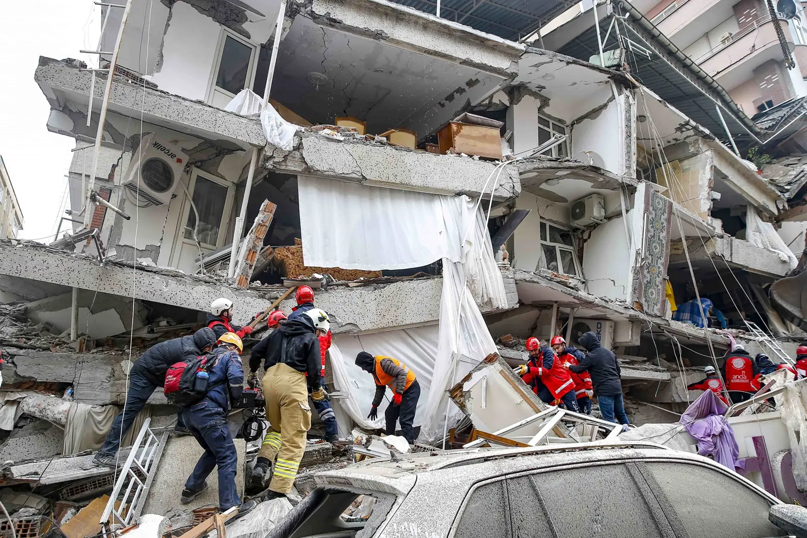 Rescue workers searching the rubble of a collapsed building