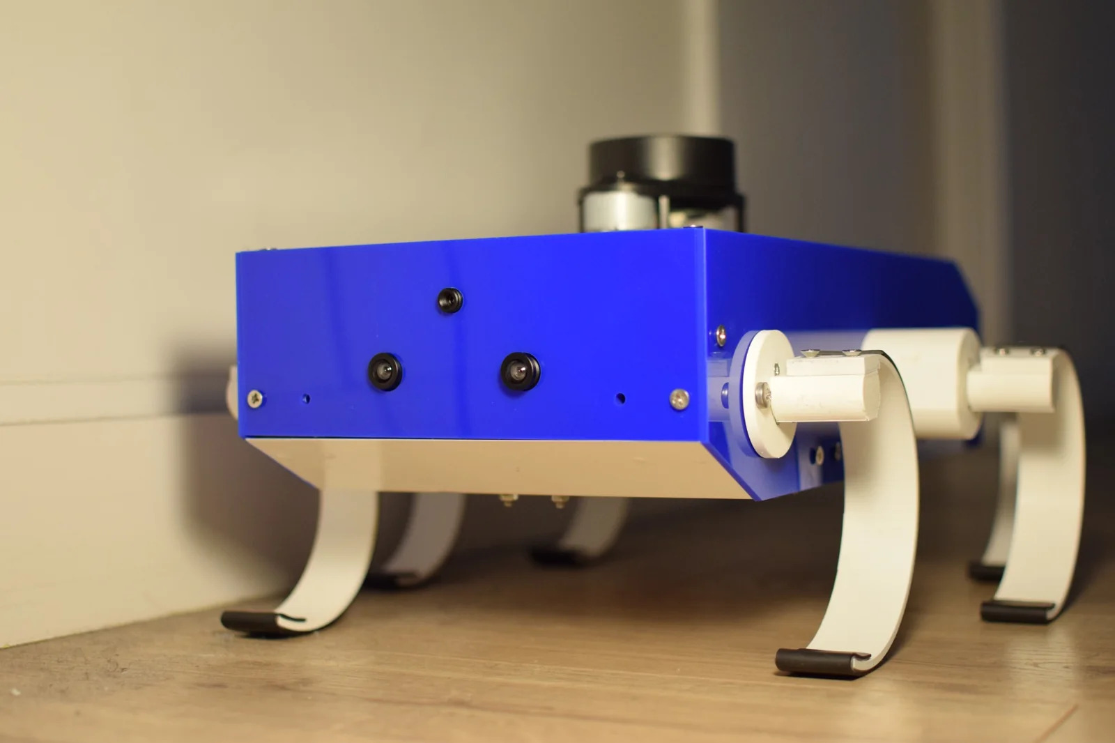 Blue DR-Hex robot with curved white legs, front cameras and a top-mounted LiDAR.
