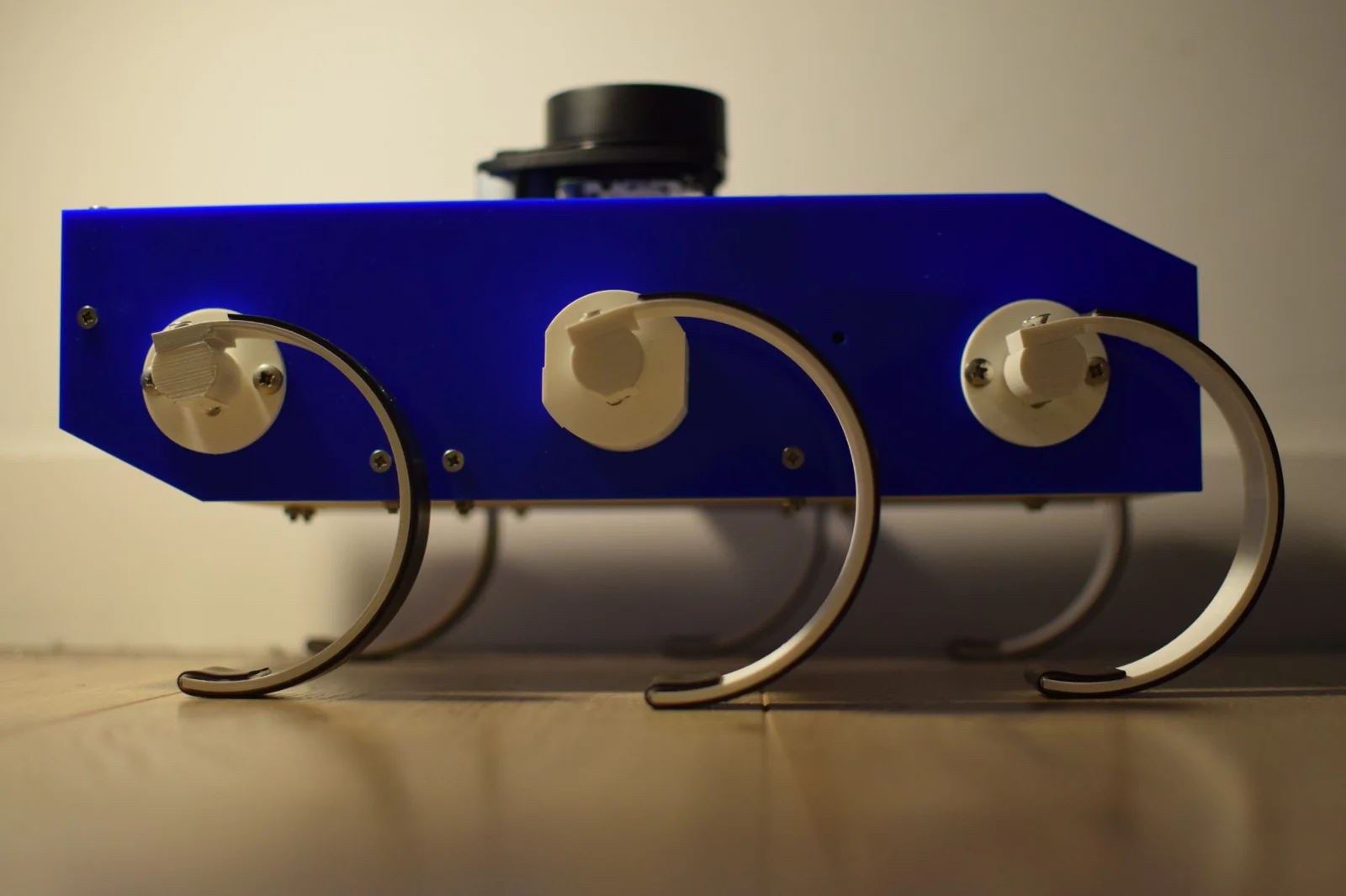 Side view of DR-Hex showing three curved legs and the chassis.