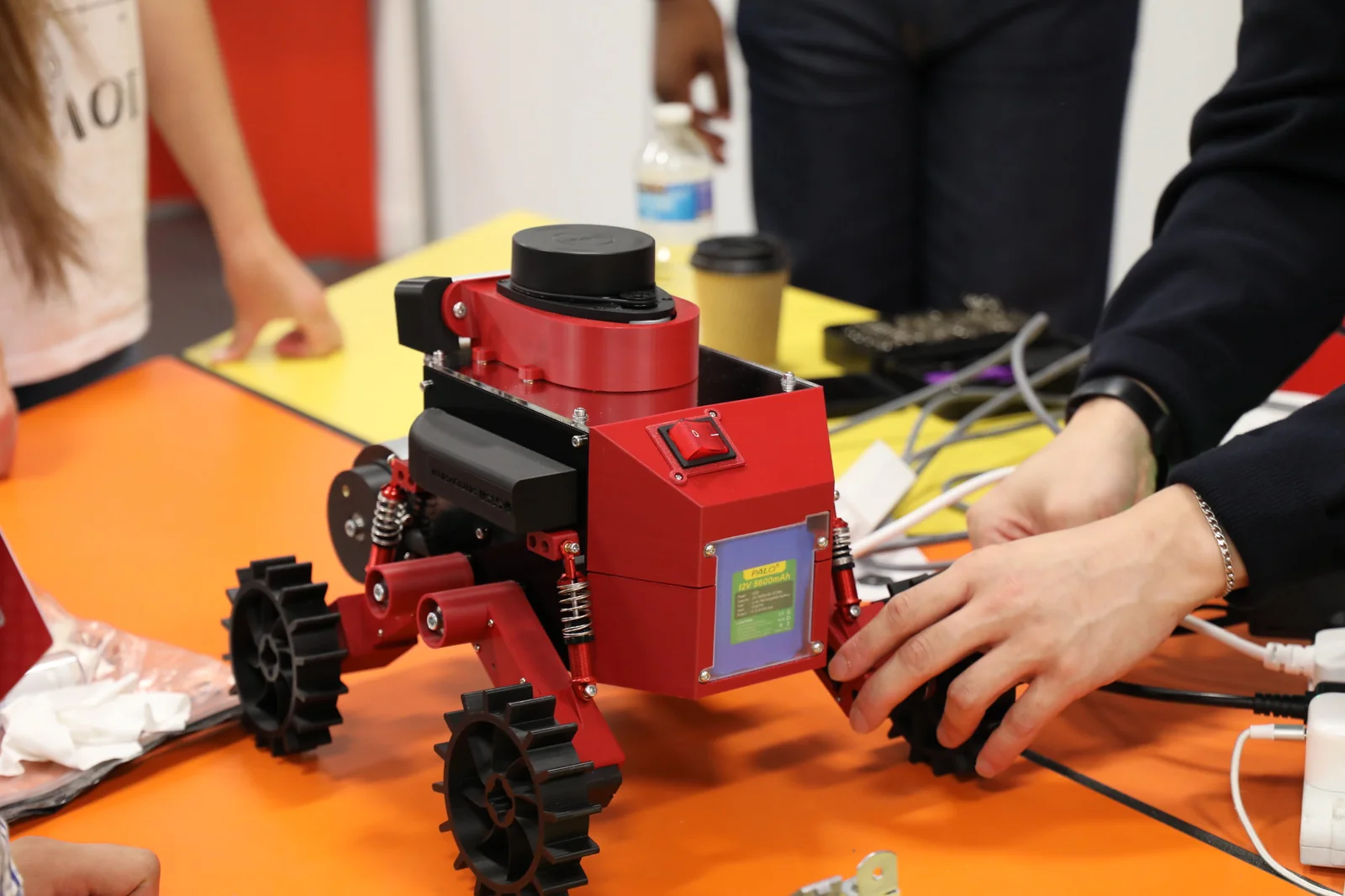 Team members preparing the rover on a workbench.