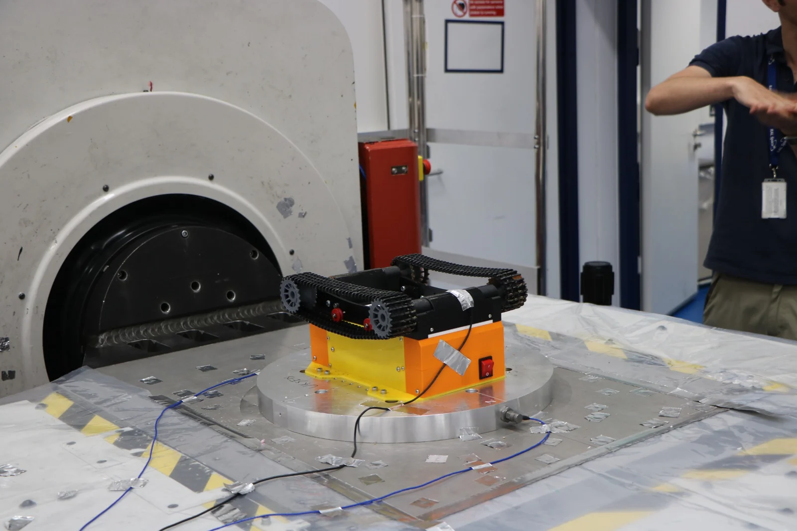 Tracked rover supported on an orange stand in a RAL Space laboratory.