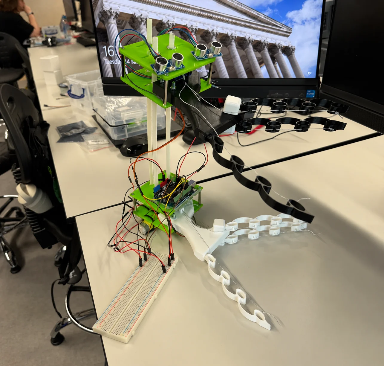 Assembled tree-climbing robot with two compliant grippers, vertical rods and electronics.